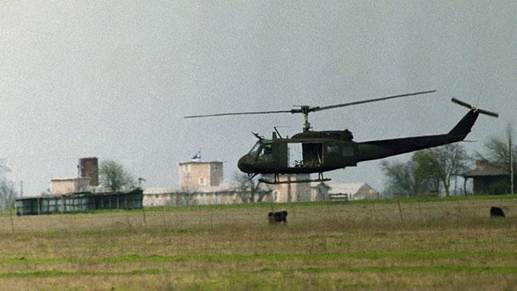 A helicopter hovers near the Branch Davidian compound in Waco, Texas