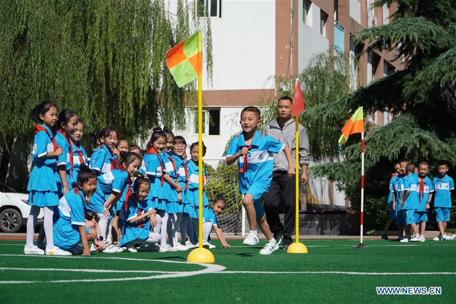 Pupils have PE class at a primary school in Longnan City, northwest China