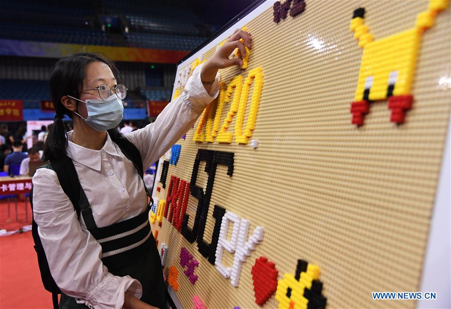 A freshman registers at the Khoo Teck Puat Gymnasium of the Peking University in Beijing, capital of China on Sept. 1, 2020. As the new school year starts, college students are returning to campus in Beijing under tight epidemic prevention and control measures. (Xinhua/Ren Chao)
