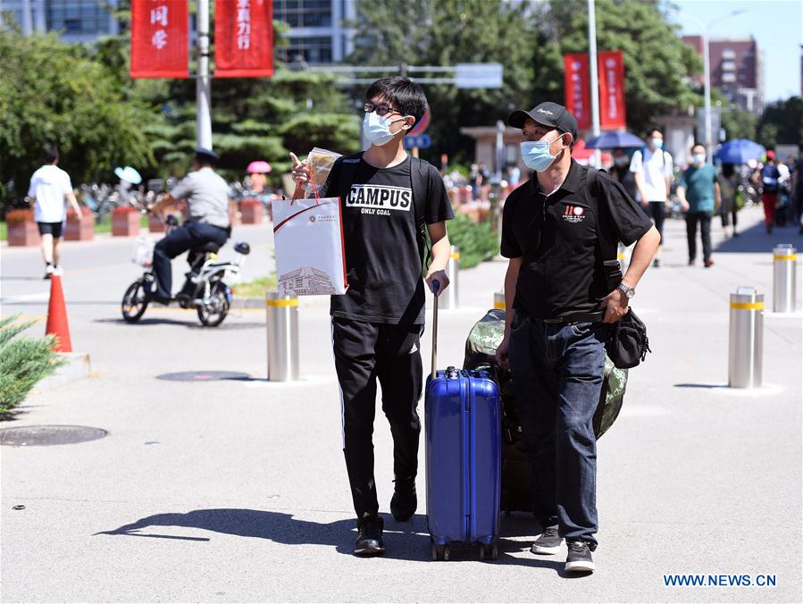 A freshman (front L) walks with his father in the campus of the Peking University in Beijing, capital of China on Sept. 1, 2020. As the new school year starts, college students are returning to campus in Beijing under tight epidemic prevention and control measures. (Xinhua/Ren Chao)