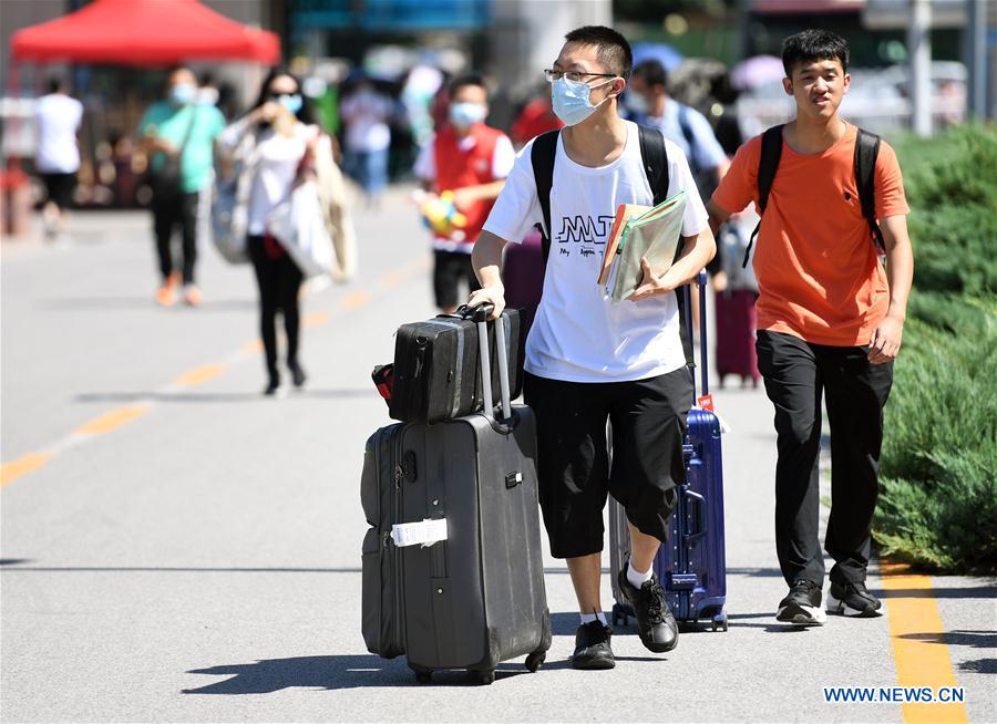 A freshman (front) walks in the campus of the Peking University in Beijing, capital of China on Sept. 1, 2020. As the new school year starts, college students are returning to campus in Beijing under tight epidemic prevention and control measures. (Xinhua/Ren Chao)