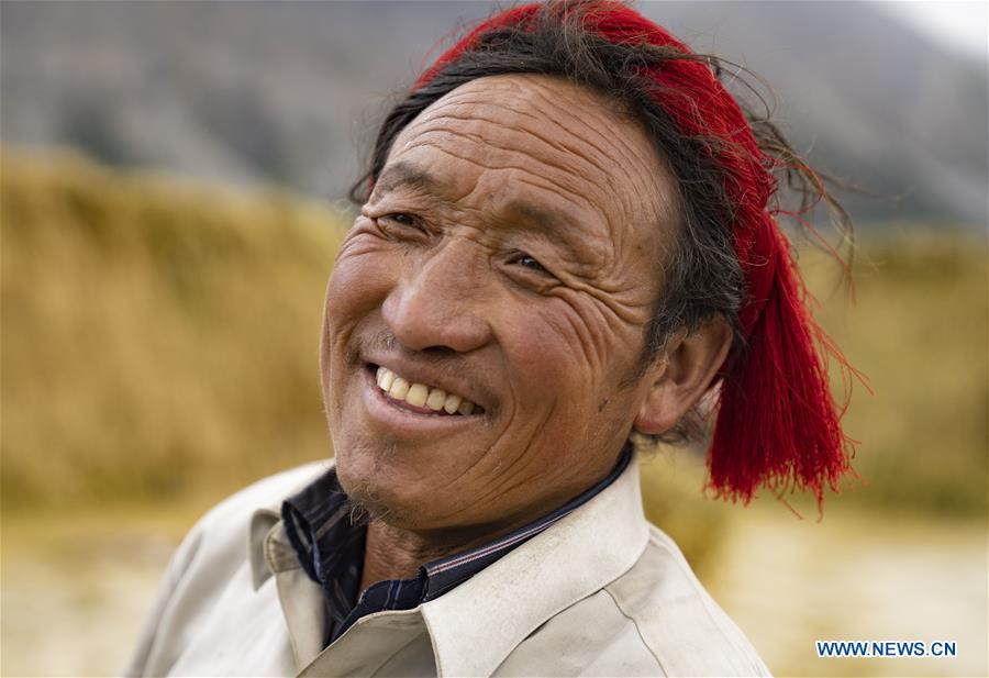 A farmer is seen in a field in Kangsar Village, Qamdo City of southwest China