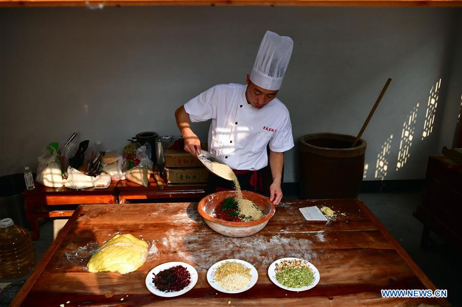 Zhang Xu prepares mooncake stuffing at the mooncake bakery Jingshengchang in Xiayi County, Shangqiu, central China