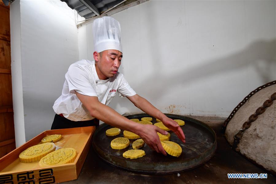 Zhang Xu bakes mooncakes at the mooncake bakery Jingshengchang in Xiayi County, Shangqiu, central China