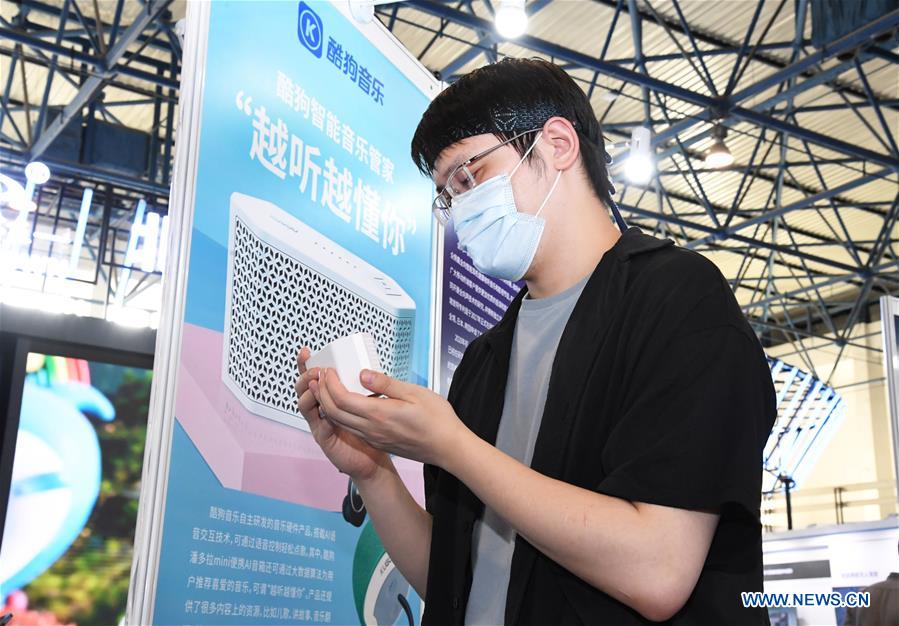 A staff member demonstrates a smart speaker during the 23rd China Beijing International High-tech Expo in Beijing, capital of China, Sept. 17, 2020. The 23rd China Beijing International High-tech Expo is held together with the 2020 Zhongguancun Forum (ZGC Forum), showcasing the latest technological achievements to the world. (Xinhua/Ren Chao)