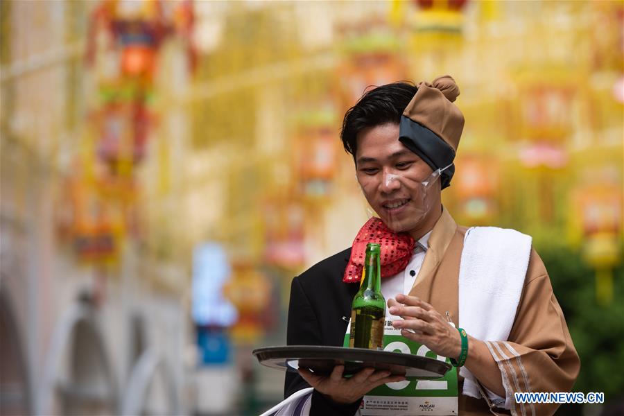 A contestant takes part in the tray race in Macao, south China, Sept. 27, 2020. A tray race running from the Ruins of St. Paul