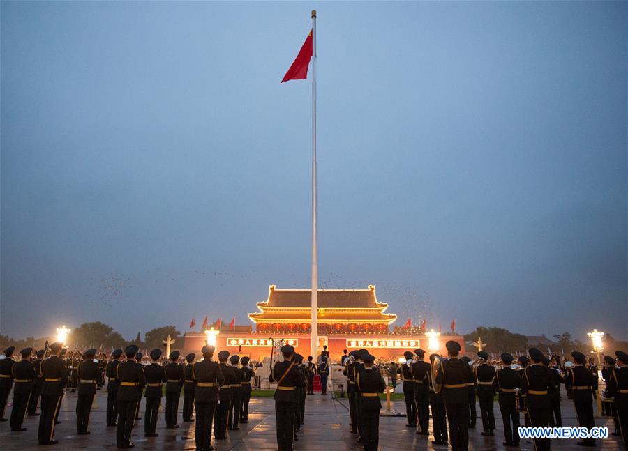 A flag-raising ceremony to celebrate the 71st anniversary of the founding of the People