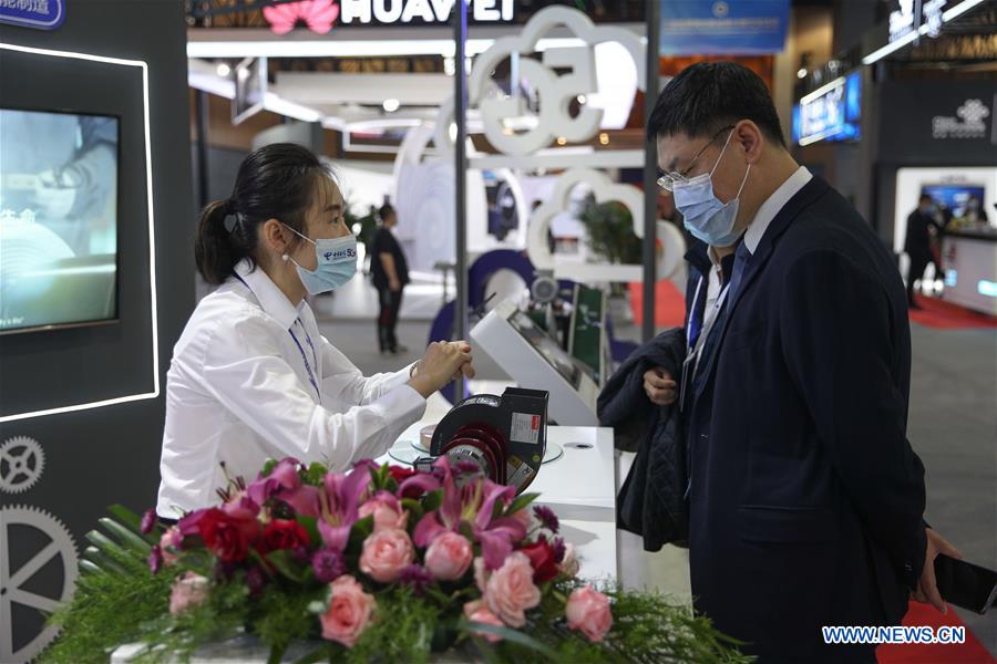 A visitor looks at an exhibit during the 2020 Global Industrial Internet Conference (GIIC) in Shenyang, capital of northeast China