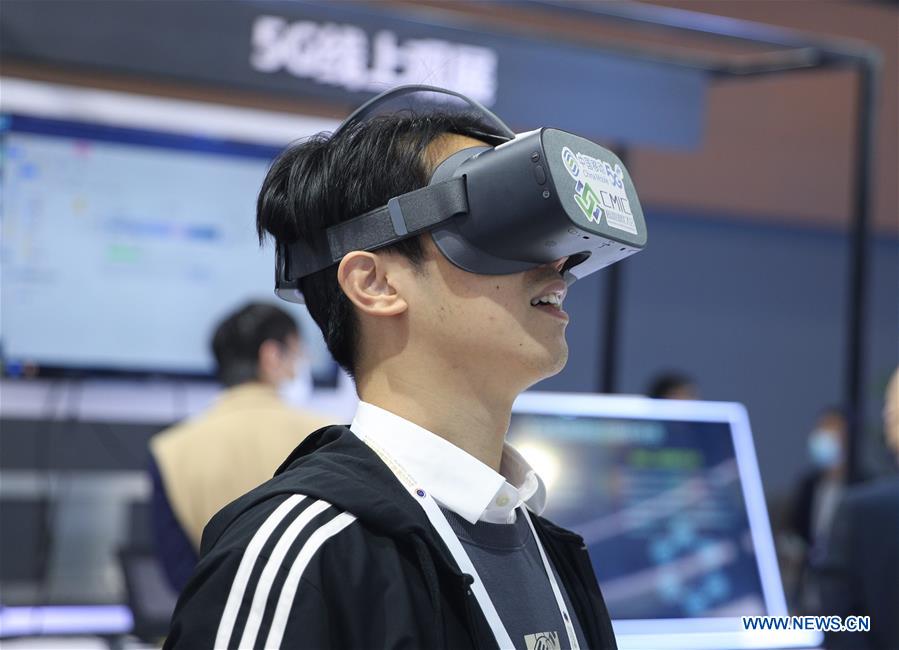 A visitor tries VR (Virtual Reality) glasses during the 2020 Global Industrial Internet Conference (GIIC) in Shenyang, capital of northeast China