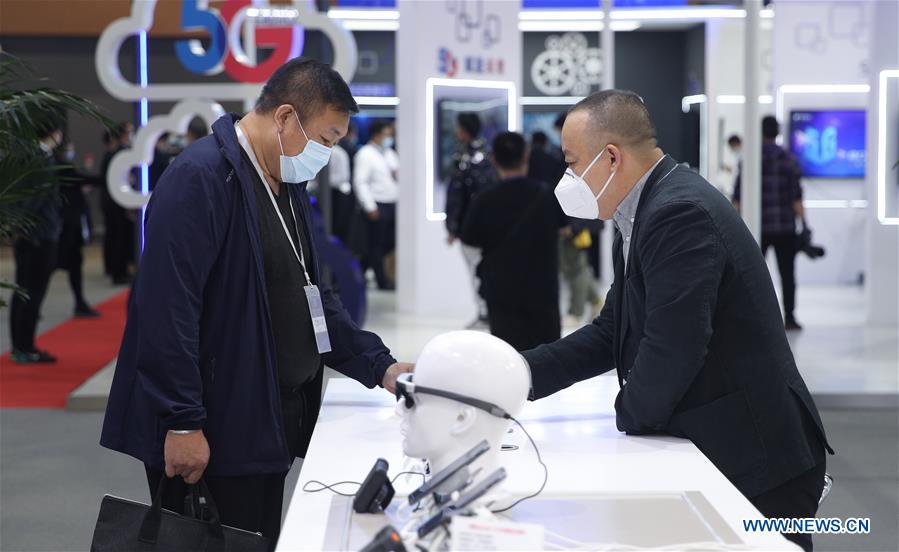 A visitor looks at an exhibit during the 2020 Global Industrial Internet Conference (GIIC) in Shenyang, capital of northeast China