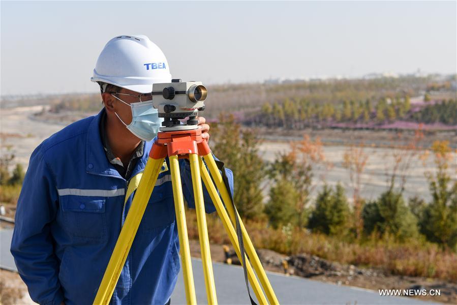 A staff member works at a construction site of an ecological project in Changji City, northwest China