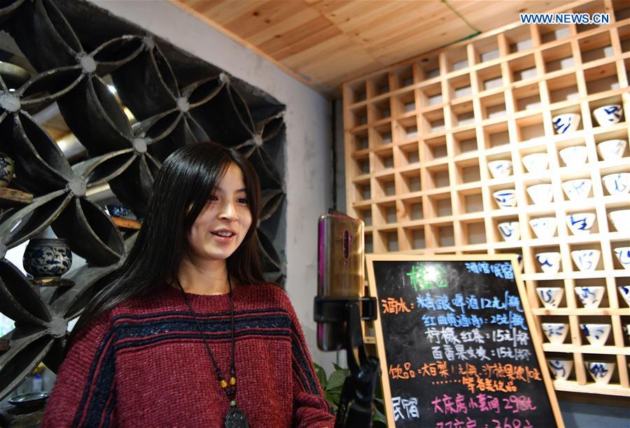 Zeng Wanzhen, the wife of Hu Wenliang, a professional designer introduced to Longtan Village who started a cultural and creative space here, introduces their home inn through the Internet in Longtan Village of Pingnan County in Ningde City, southeast China