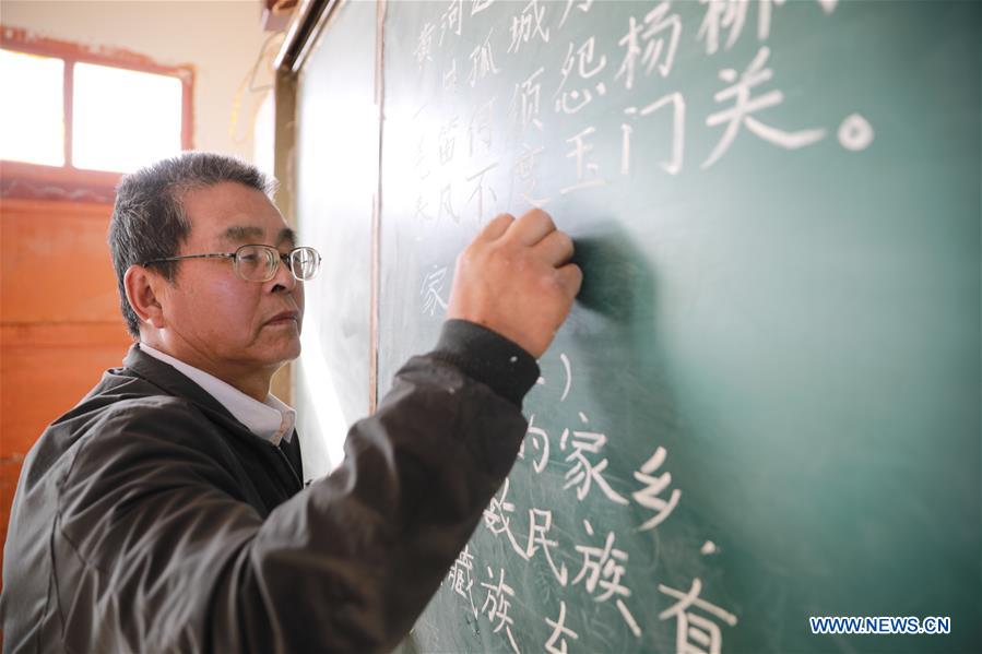 Wang Jianlin gives a lesson in Changshan School, Huining County, northwest China