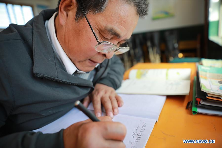 Wang Jianlin prepares for his lesson in Changshan School, Huining County, northwest China