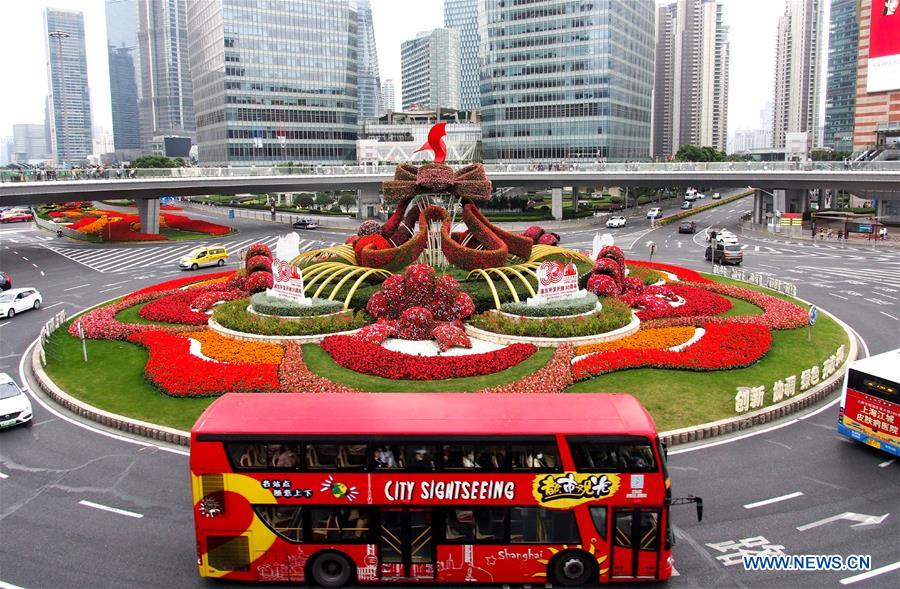 A city sightseeing bus runs in the street of the Lujiazui area in east China