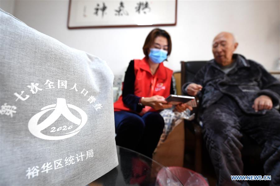 Census taker (L) registers residents
