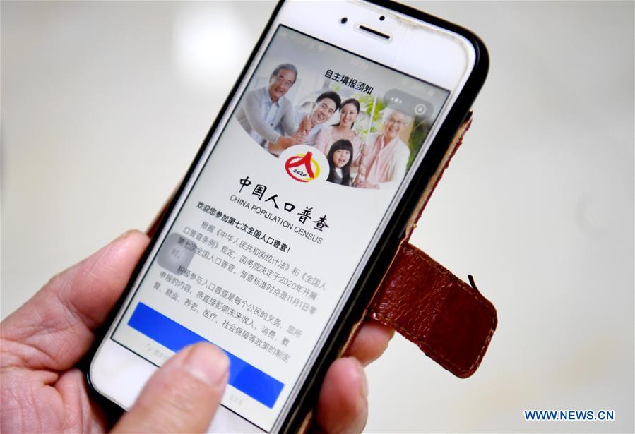 A resident registers information of a household on the phone in Shijiazhuang, north China