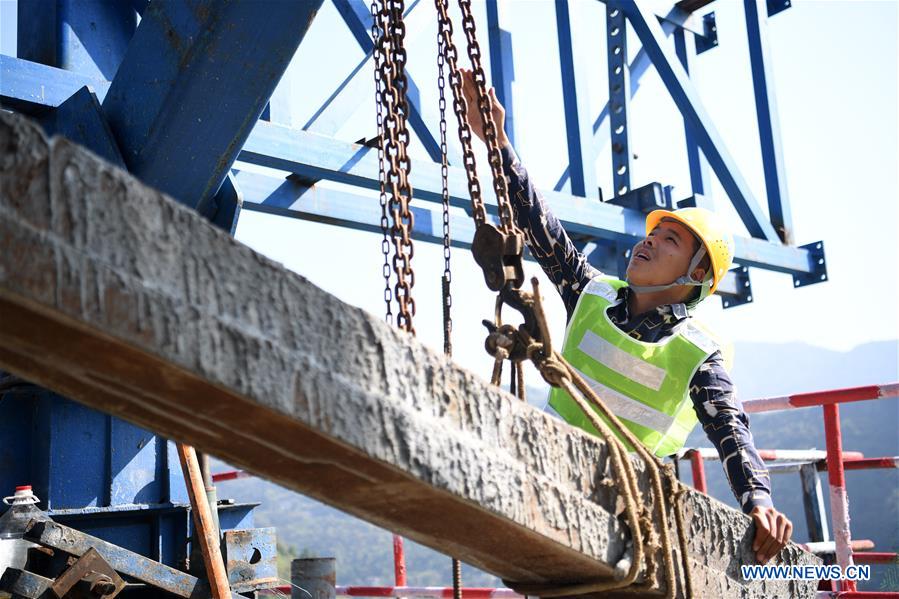 A constructor works at the construction site of a highspeed railway bridge over Tangxi River in Yunyang Township in southwest China