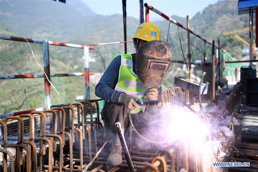 A constructor works at the construction site of a highspeed railway bridge over Tangxi River in Yunyang Township in southwest China