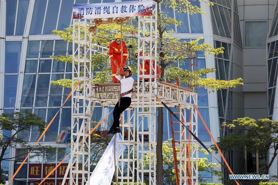 A resident practises cable descent under the instruction of firefighters in Xiamen, southeast China