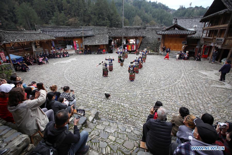 Tourists watch dance performances at Langde Village of Miao ethnic group in Leishan County, Qiandongnan Miao and Dong Autonomous Prefecture, southwest China