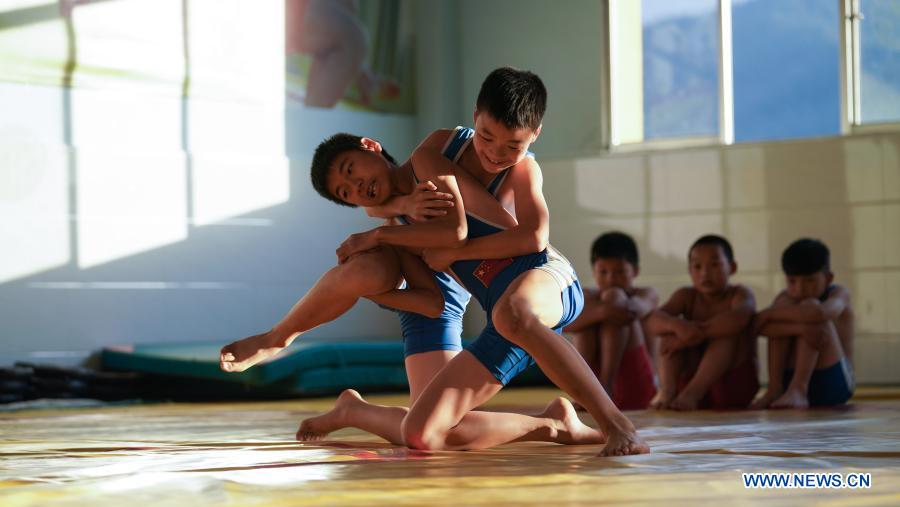 Photo taken on Nov. 11, 2020 shows students practising wrestling at the stadium of Matian School in Pingxiang, east China
