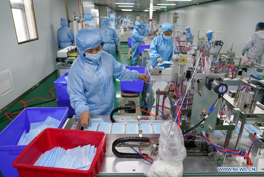 Employees make face masks at a workshop of a state-owned enterprise in Xi