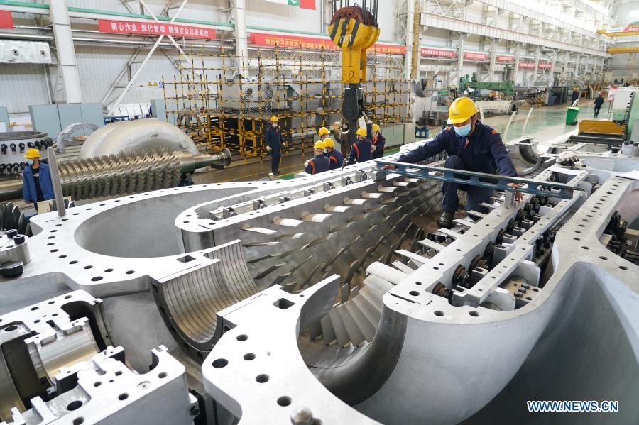 An engineer assembles an axial-flow compressor at a workshop of the Shaanxi Blower (Group) Co., Ltd., a state-owned enterprise, in Xi