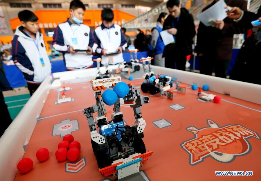 Contestants participate in a robot rescue match during a robotics competition for middle and primary school students in Jimo District of Qingdao, east China