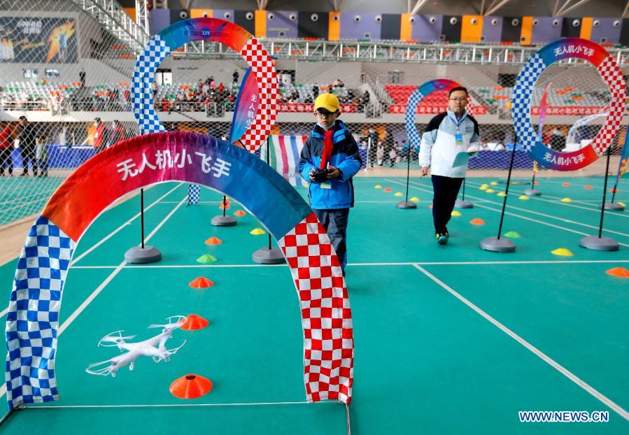 Contestants participate in a drone match during a robotics competition for middle and primary school students in Jimo District of Qingdao, east China