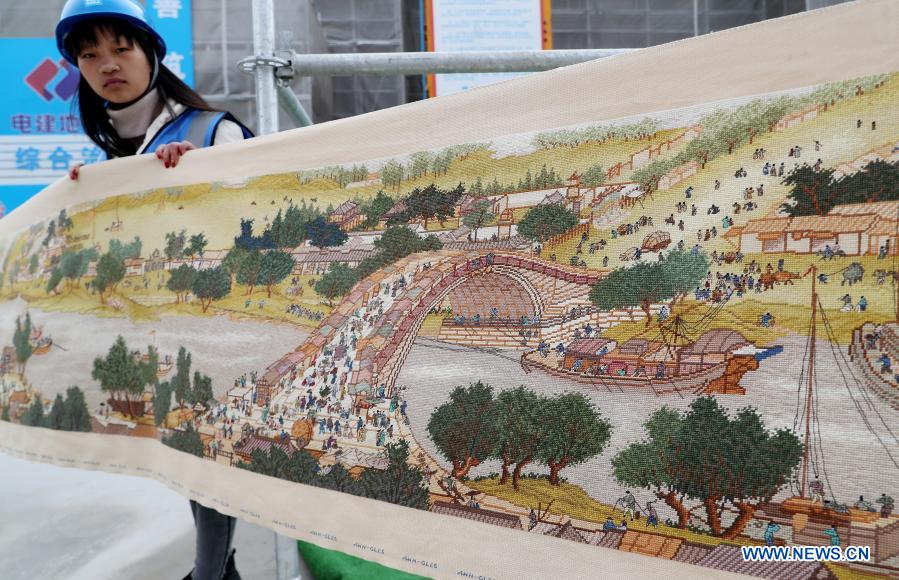 Photo taken on Dec. 2, 2020 shows part of a long cross-stitch scroll created by Zhang Xingfa at a construction site in east China