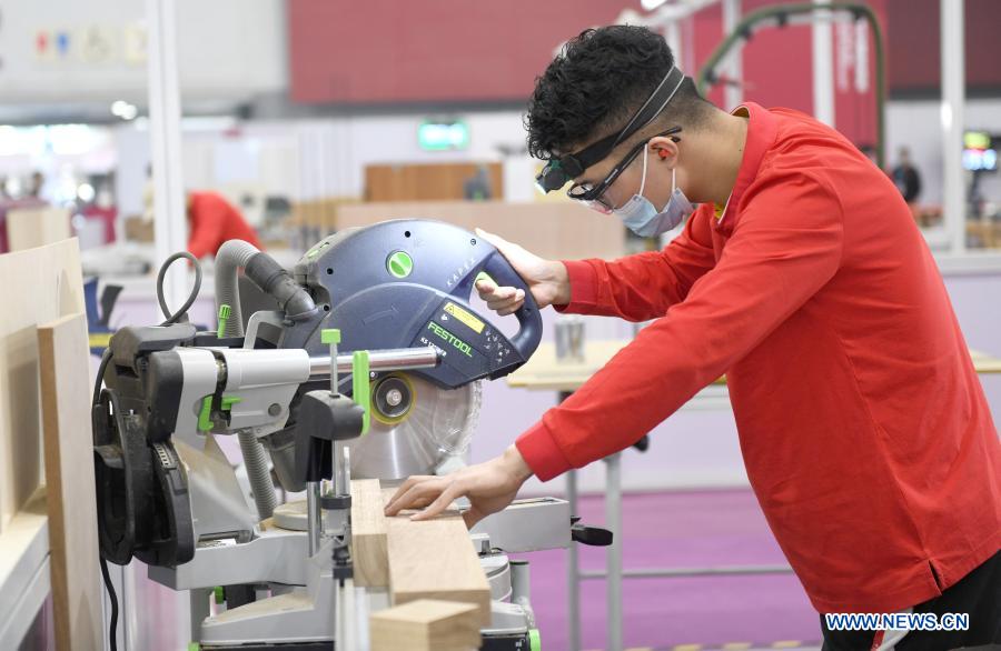 A contestant cuts wood during the first vocational skills competition in Guangzhou, south China