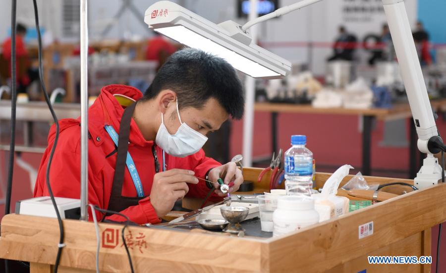 A contestant processes jewellery during the first vocational skills competition in Guangzhou, south China
