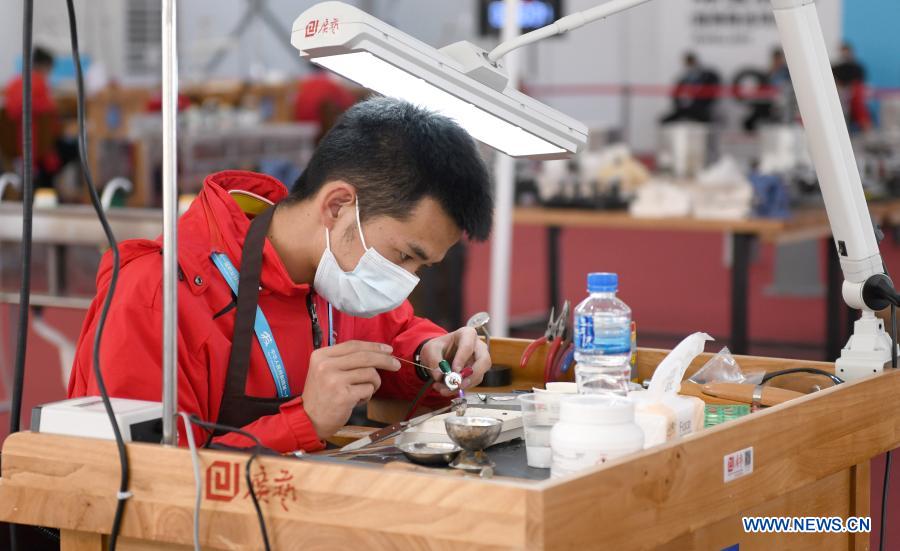 A contestant processes jewellery during the first vocational skills competition in Guangzhou, south China