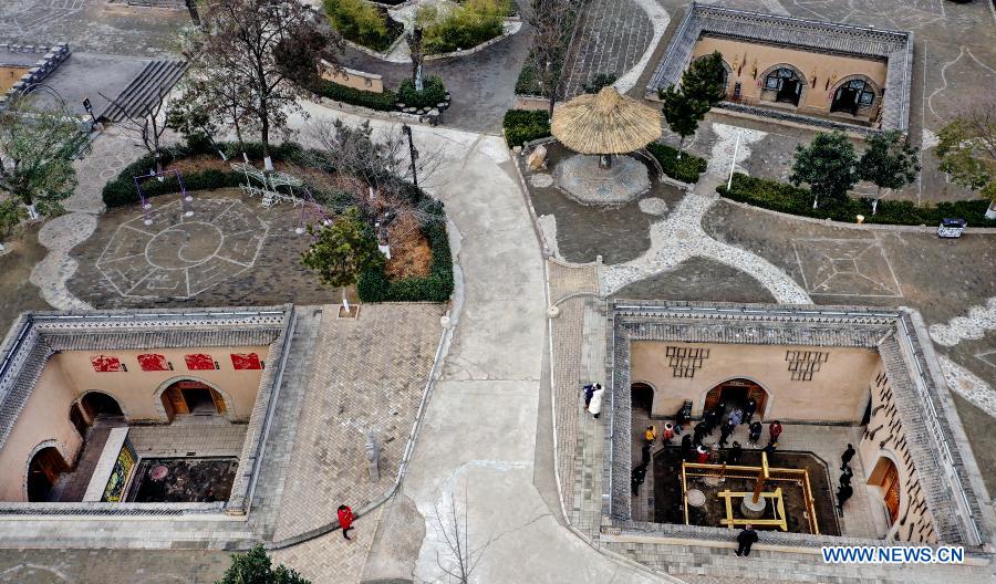 Aerial photo taken on Dec. 10, 2020 shows tourists visiting traditional Dikengyuan residences in Beiying Village, Zhangbian Township, Shanzhou District, Sanmenxia City of central China