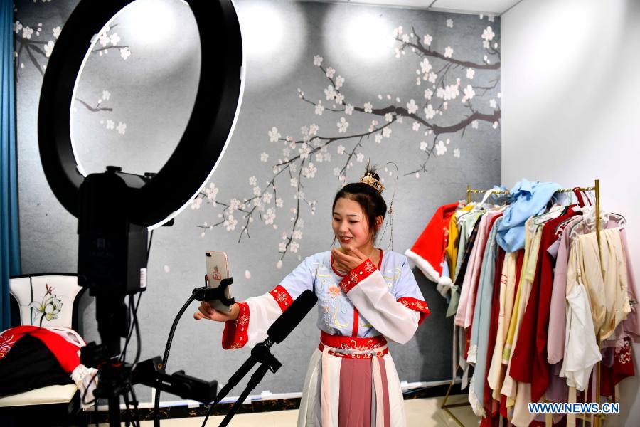 A student promotes hanfu via livestreaming at a secondary vocational school in Caoxian County, east China