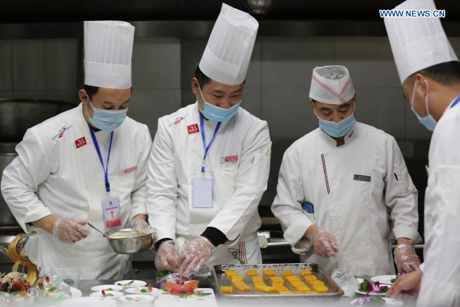 Chefs prepare food during a cooking competition in Yinan county of Linyi City, east China