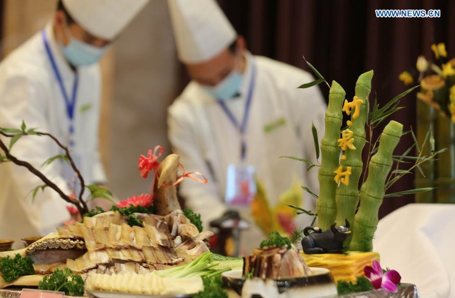 Chefs prepare food during a cooking competition in Yinan county of Linyi City, east China