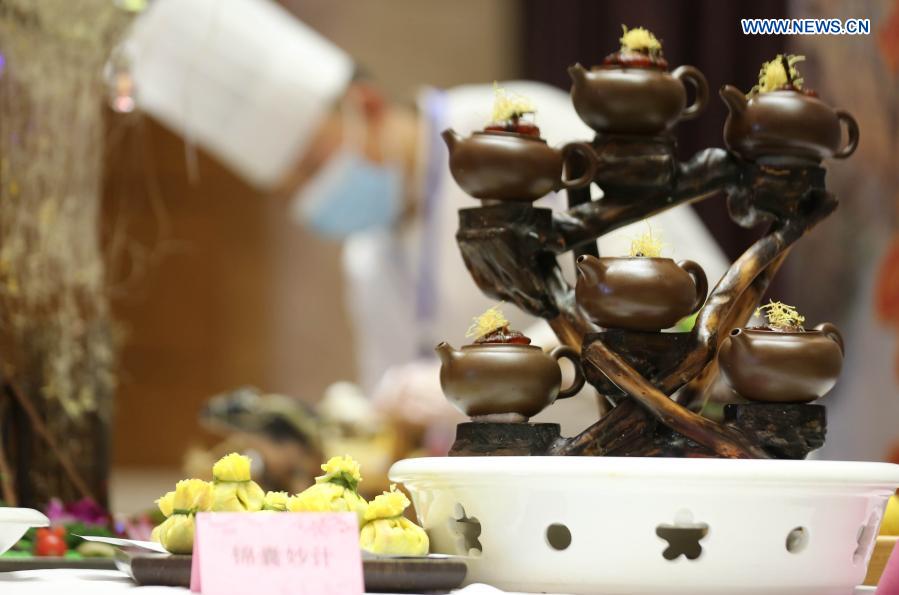 A chef prepares food during a cooking competition in Yinan county of Linyi City, east China