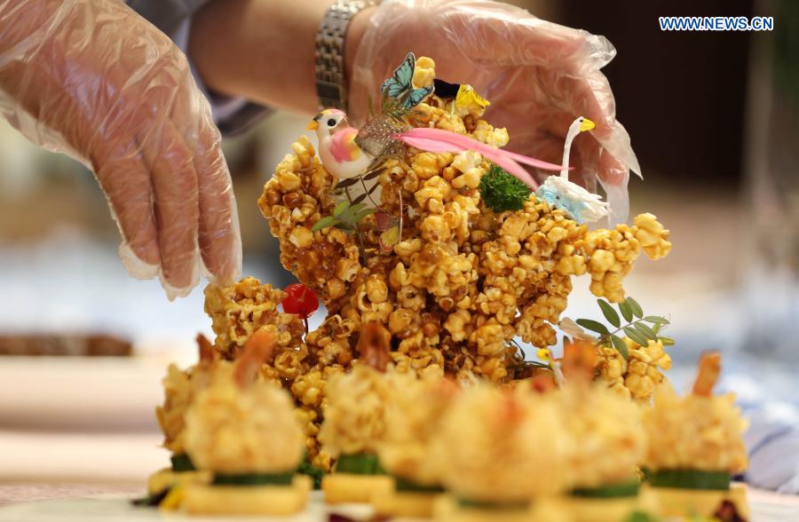 A chef prepares food during a cooking competition in Yinan county of Linyi City, east China