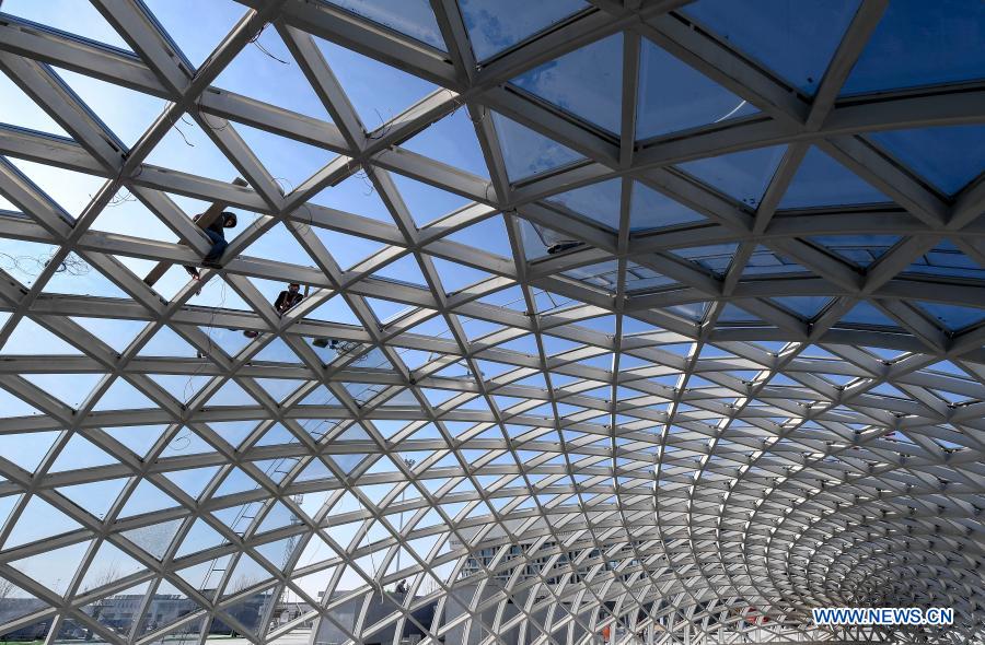 Staff members work at the construction site of the Qingyang Railway Station along the Yinchuan-Xi