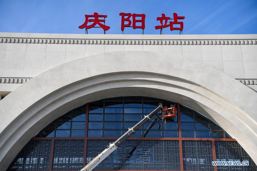 Staff members do cleaning work at the Qingyang Railway Station along the Yinchuan-Xi