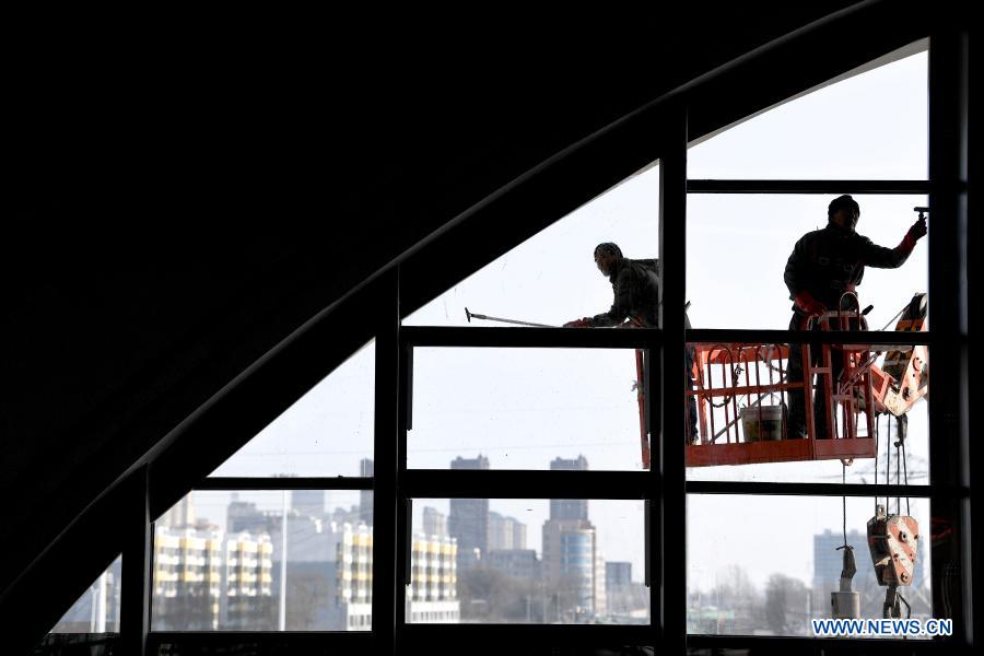 Staff members do cleaning work at the Qingyang Railway Station along the Yinchuan-Xi