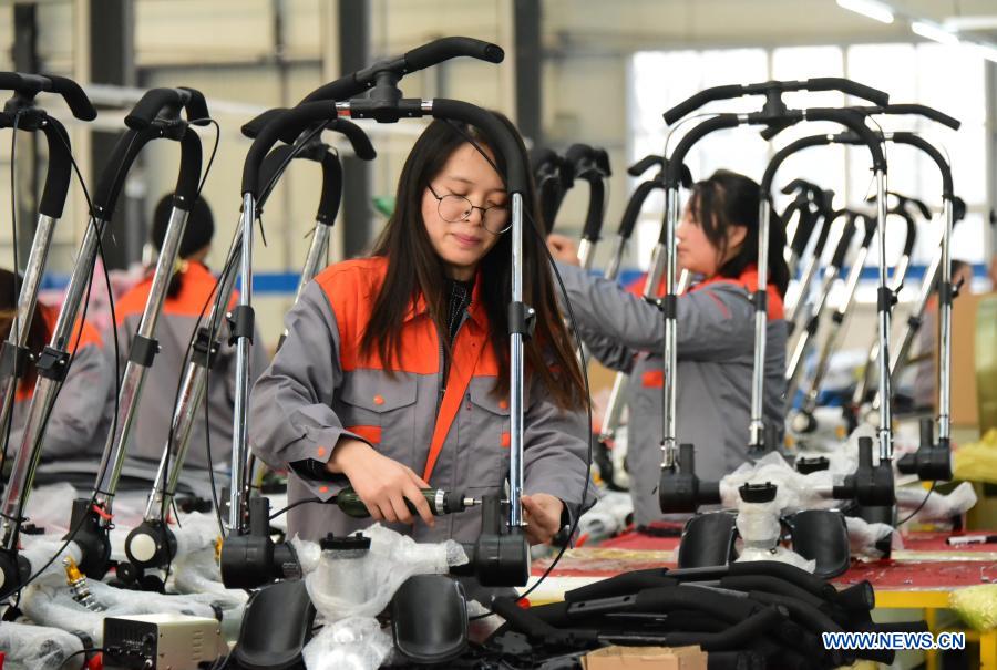 Employees assemble products in Quzhou County, Handan City of north China