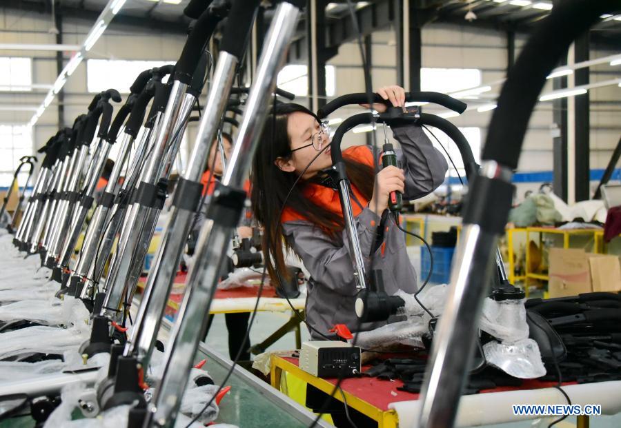 An employee assembles products in Quzhou County, Handan City of north China