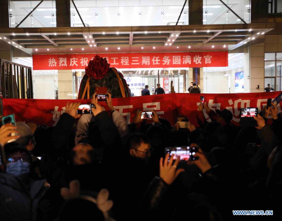 People celebrate the arrival of the return capsule of China