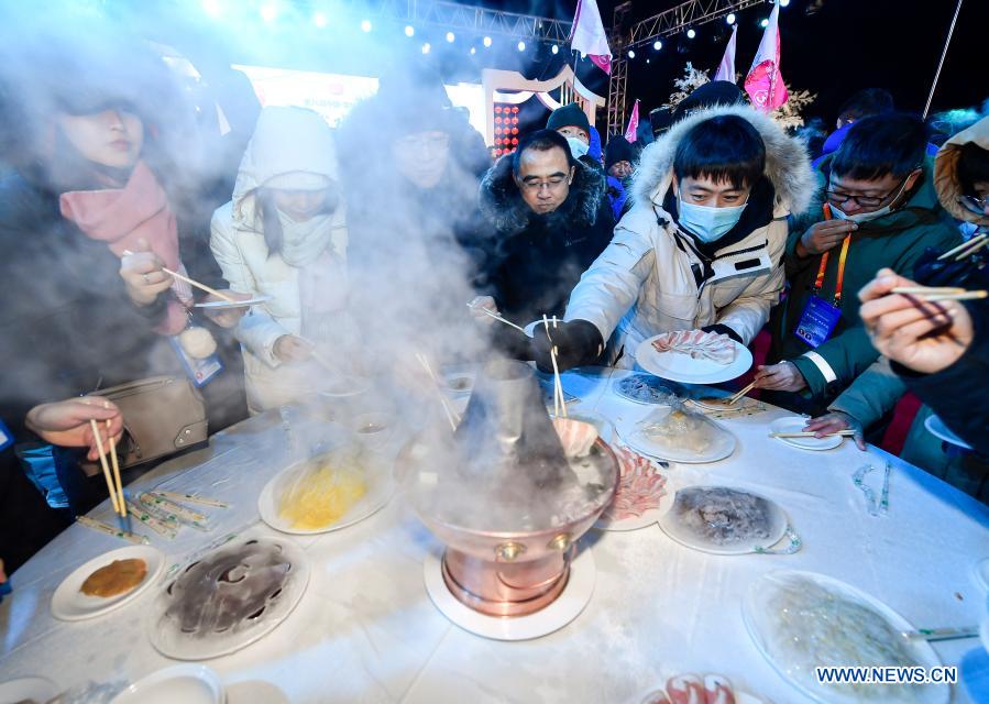 Visitors have outdoor hotpot during the 26th International Rime Ice and Snow Festival (Jilin, China) in Jilin City, northeast China