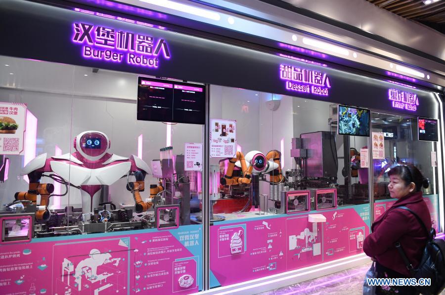 Photo taken on Jan. 15, 2020 shows the burger robot, dessert robot and frying robot serving at a smart restaurant in Guangzhou, capital of south China