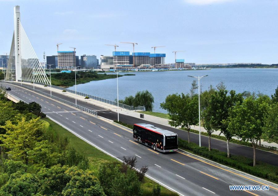 Aerial photo taken on Aug. 18, 2020 shows a self-driving bus of the autopilot bus line 1 running on a road in Zhengzhou, central China