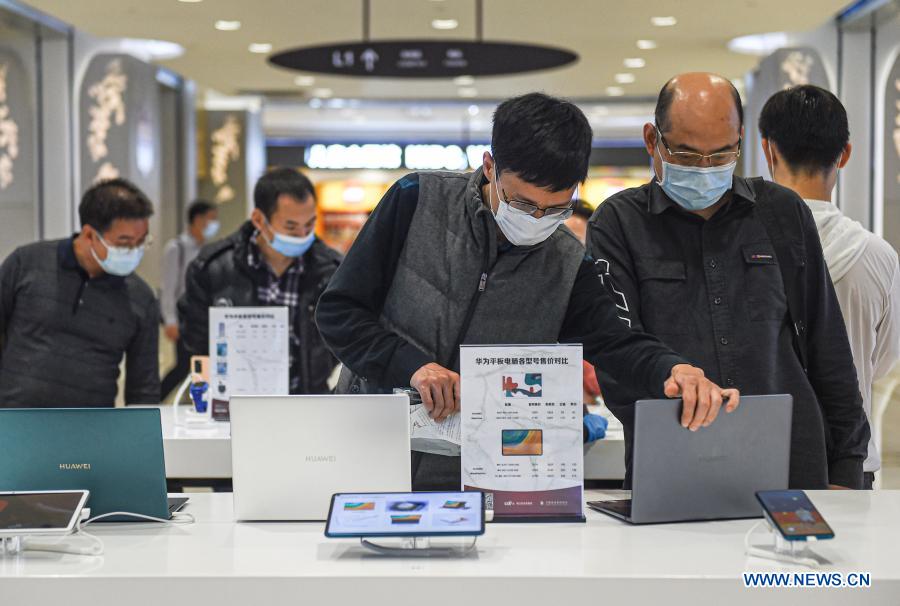 Consumers shop at a duty-free shop at Sun Moon Plaza in Haikou, capital of south China